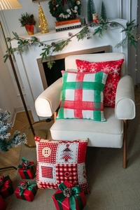 Close-up of festive Christmas cushion covers with snowflake and plaid holiday patterns