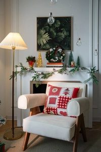 Close-up of a festive patchwork cushion with holiday patterns on a cozy armchair