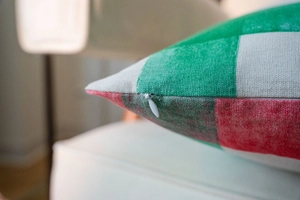 Detail shot of the invisible zipper closure on the red and green plaid pillow cover