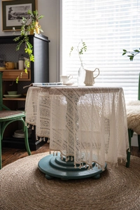 Detailed macro shot of vintage crochet lace tablecloth with fringe edge details