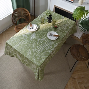 Rectangular green tablecloth with white botanical leaf print and natural cotton linen texture