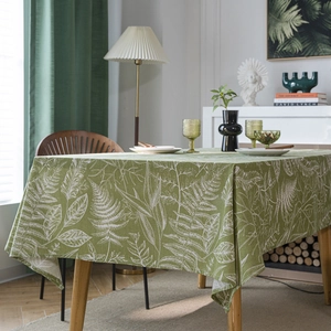 Green rectangle tablecloth with white leaf patterns in a cozy American style home setting