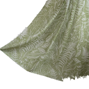 Green semi-blackout kitchen curtain featuring white tropical leaf pattern and raw edges