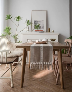 Detailed view of the woven geometric pattern and handmade tassel fringe on table runner