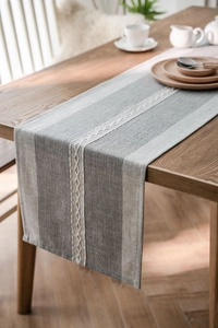 Close-up of geometric hollow woven pattern and striped texture on Nordic table runner