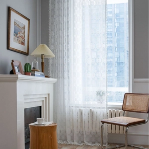 White crochet lace window curtain with vintage floral patterns and tassel trim for bedroom