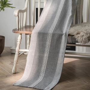 Nordic geometric jacquard table runner with fringe on a vintage white wooden chair