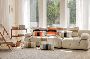 Detail of bohemian textured cushion covers with colorful stripes and tassel accents