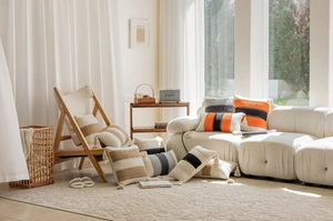 Close-up of Bohemian woven pillow covers with colorful stripes and elegant tassel details