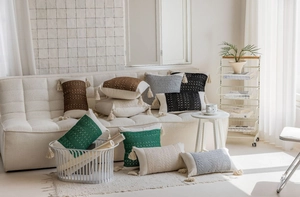 Close-up of bohemian style jacquard throw pillows with handmade tassels on a white sofa