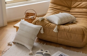 Detail of bohemian jacquard pillow covers with geometric embroidery and corner tassels