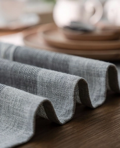 Macro texture of gray jacquard table runner fabric with natural linen weave detail