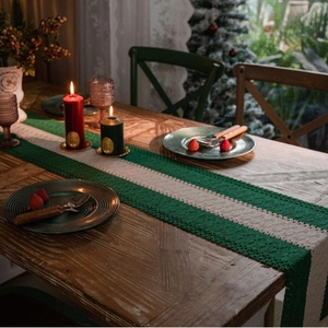 Green and cream striped crochet table runner with tassels for holiday home decoration