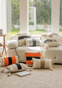 Detail of bohemian cotton linen pillowcase with tufted patterns and tassels decoration