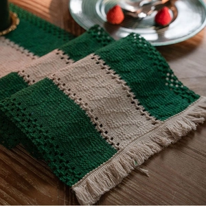 Green and cream striped cotton linen table runner with woven texture and tassels