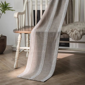 Nordic woven table runner with braided white accents on beige cotton linen fabric