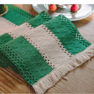 Striped cotton linen table runner with fringes on a rustic wooden dining table