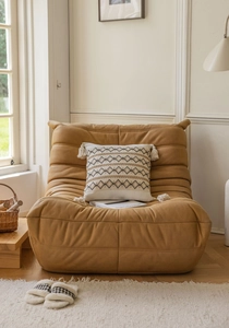 Detailed texture of ginger yellow Togo style sofa with ivory tassel diamond pattern pillow