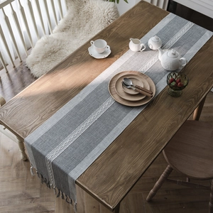 Nordic grey jacquard table runner with white braided pattern and elegant grey tassels