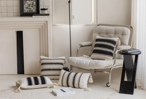 Detailed texture of Boho jacquard pillow cover with black geometric patterns and tassels
