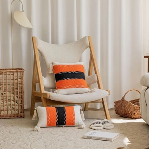 Bohemian woven throw pillow set with orange and black geometric stripes and tassels