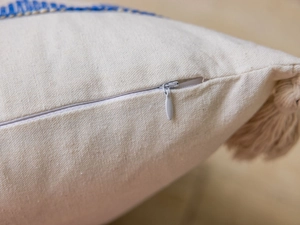 Detail of invisible zipper, tassel fringe, and woven texture on American jacquard cushion