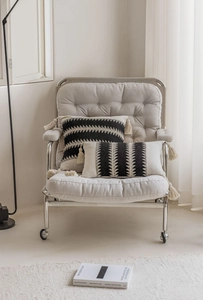 Detailed view of bohemian style woven pillow covers with tassels and geometric patterns