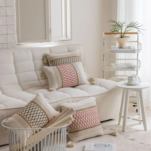 Bohemian style cream cushion cover with colorful geometric embroidery and tassels