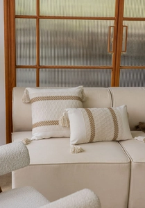 Close-up of bohemian jacquard throw pillows with cotton tassels and hand-woven textures