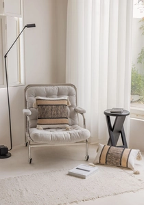 Detail of bohemian jacquard pillow covers with textured stripes and handcrafted tassels