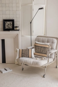 Detail of bohemian woven striped decorative pillow covers with elegant cream tassels