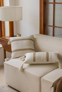 Detail of bohemian jacquard pillow cover with tassels and ethnic woven patterns