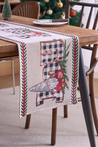 Close-up of Christmas gnome table runner with buffalo plaid pattern on wooden table