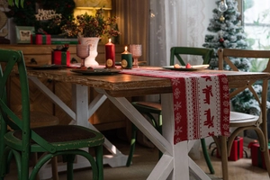 Detailed close-up of Christmas table runner with reindeer and snowflake patterns