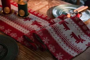 Detail of Christmas table runner with reindeer motifs and geometric snowflake patterns