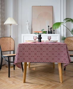 Detailed view of red bohemian tablecloth with white geometric diamond patterns and texture