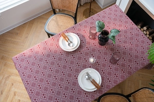 Detailed top view of red and white jacquard tablecloth with geometric patterns and texture