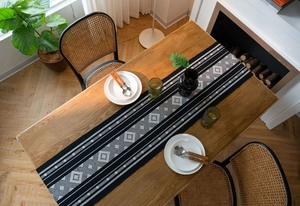 Detail of bohemian geometric diamond pattern on thick woven cotton linen table runner