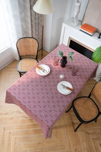 Close-up of burgundy and white geometric jacquard tablecloth with premium heavy fabric texture