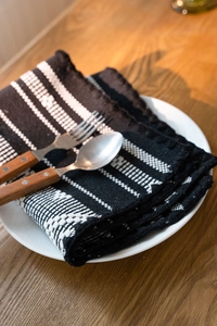 Macro shot of heavy woven table runner showing geometric stripes and textured cotton fabric