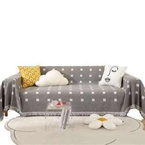 Gray geometric sofa cover with white square patterns and tassel edges for home decor