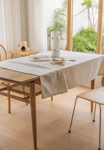 Close-up of beige plaid cotton linen tablecloth showing detailed textured weave