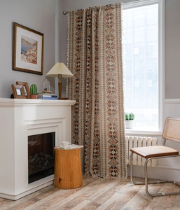 Detailed bohemian geometric pattern curtains with elegant tassel fringe in warm earth tones
