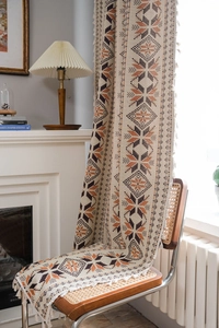 Close-up of bohemian geometric jacquard curtain with elegant fringe edge details