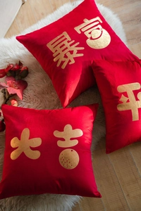 Close-up of red velvet pillow covers with gold foil Chinese auspicious characters