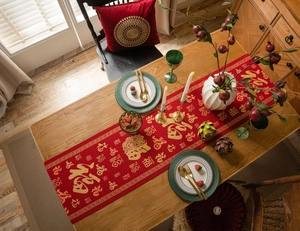 Detail of red festive table runner with golden Chinese characters and dragon patterns