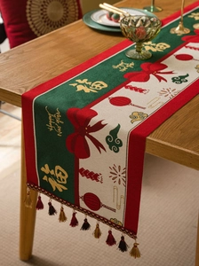 Macro detail of red festive table runner with golden Fu character and tassel pendants