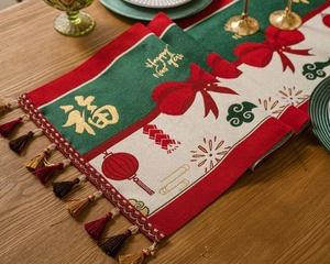 Macro shot of festive New Year table runner with gold Fu embroidery and tassels