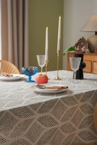 Detailed close-up of Nordic geometric leaf pattern on natural linen blend tablecloth