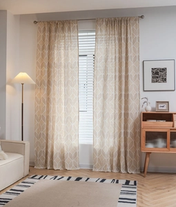 Détail d'un rideau beige semi-occultant moderne avec motif de feuilles géométriques brunes
